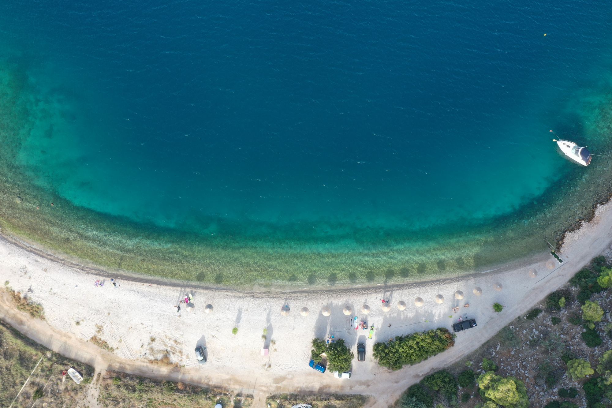Aerial view of Paralia Mikro Ammoni, the clear-water pebble beach near the Solygia lots